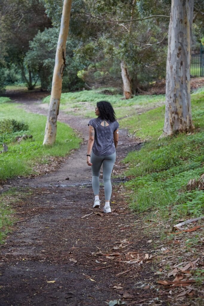 Ultimate Numerology And Fitness Guide 10 Ultimate Numerology And Fitness Guide a woman is walking down a path in the woods