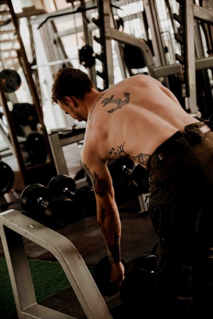 Ultimate Numerology And Fitness Guide 1 Ultimate Numerology And Fitness Guide a man with a tattoo on his back working out in a gym